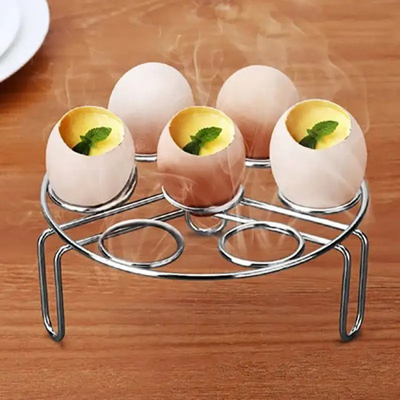 Sleek stainless steel egg topper set with six-slot steamer holding cracked eggs with yolk and mint garnish