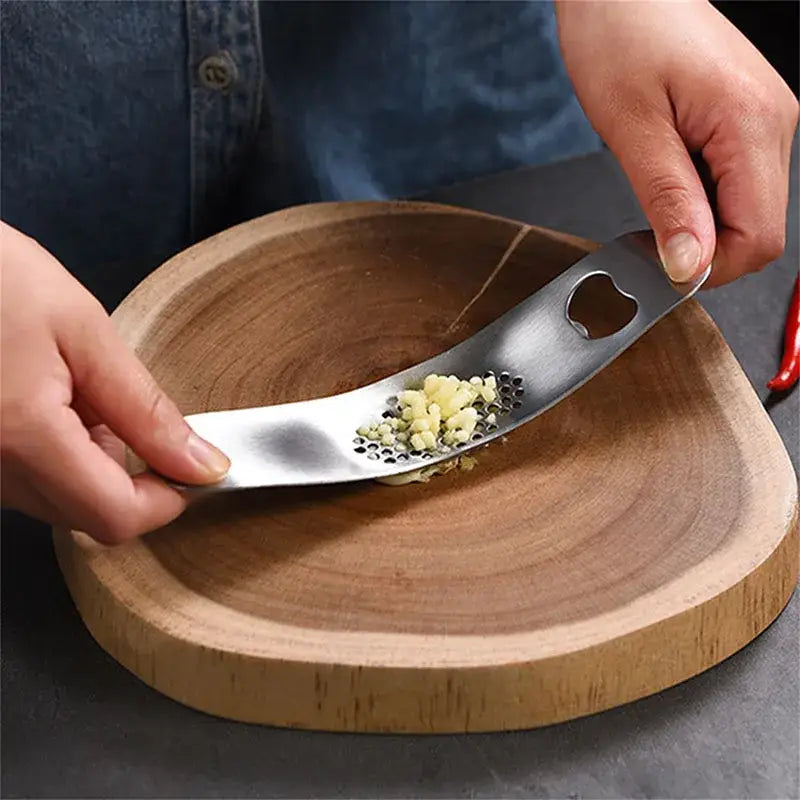Sleek stainless steel decorbites garlic press with heart-shaped handle and fine perforations for mincing cloves