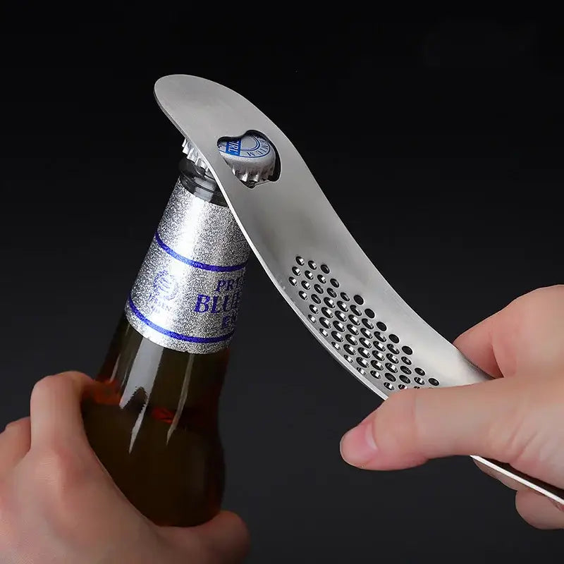 Silver metal bottle opener with perforated curved design and heart-shaped cutout for cap by decorbites garlic press