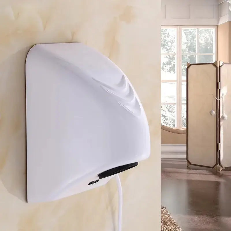Sleek white and black automatic hand dryer with curved design and black accents mounted on bathroom wall