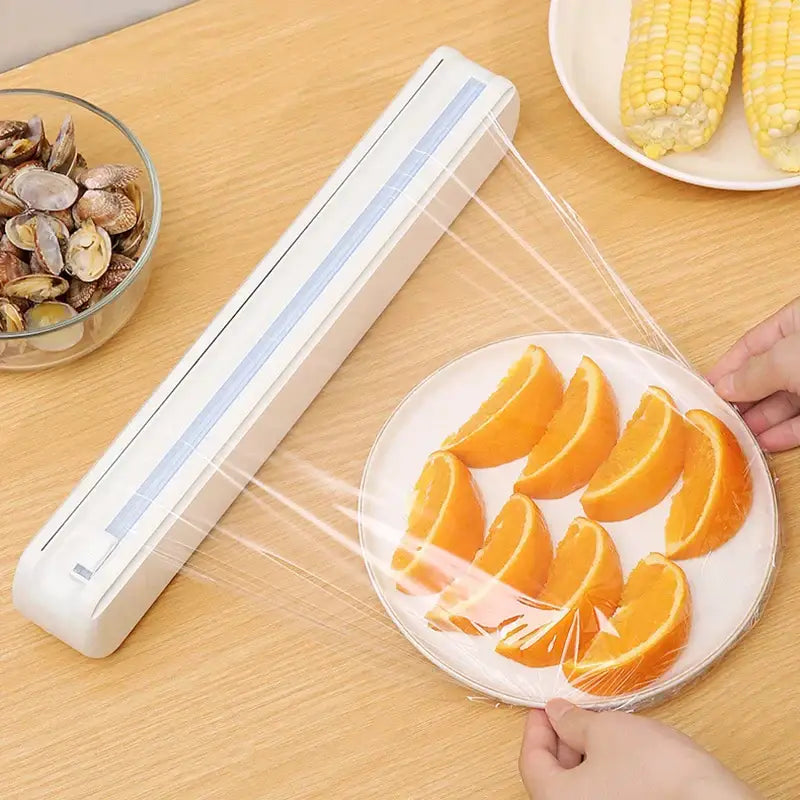 Sleek white plastic cling film dispenser cutter with a rectangular design and blue accent strip for kitchen use