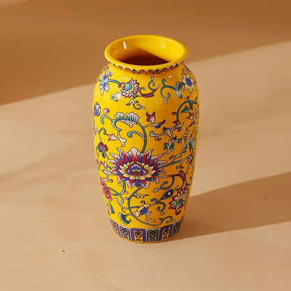 A vibrant yellow small ceramic vase with multicolored floral patterns for elegant vintage Chinese home decor