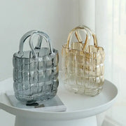 Two translucent clear glass tote bags in smoky gray and amber with woven handles and textured grid design for decorbites clear glass decor