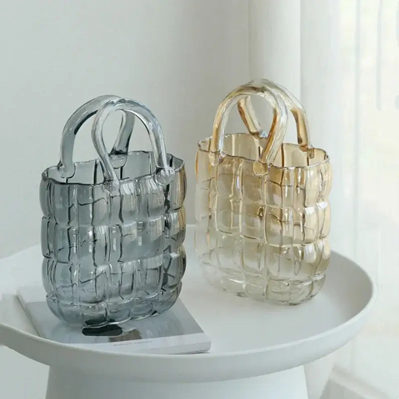 Two translucent clear glass tote bags in smoky gray and amber with woven handles and textured grid design for decorbites clear glass decor