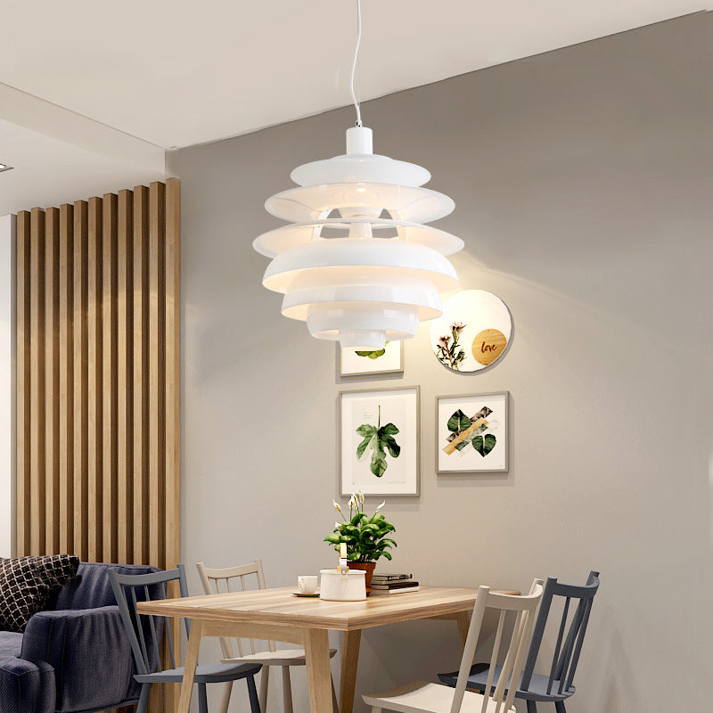 White layered pendant light with a modern design, resembling stacked discs.