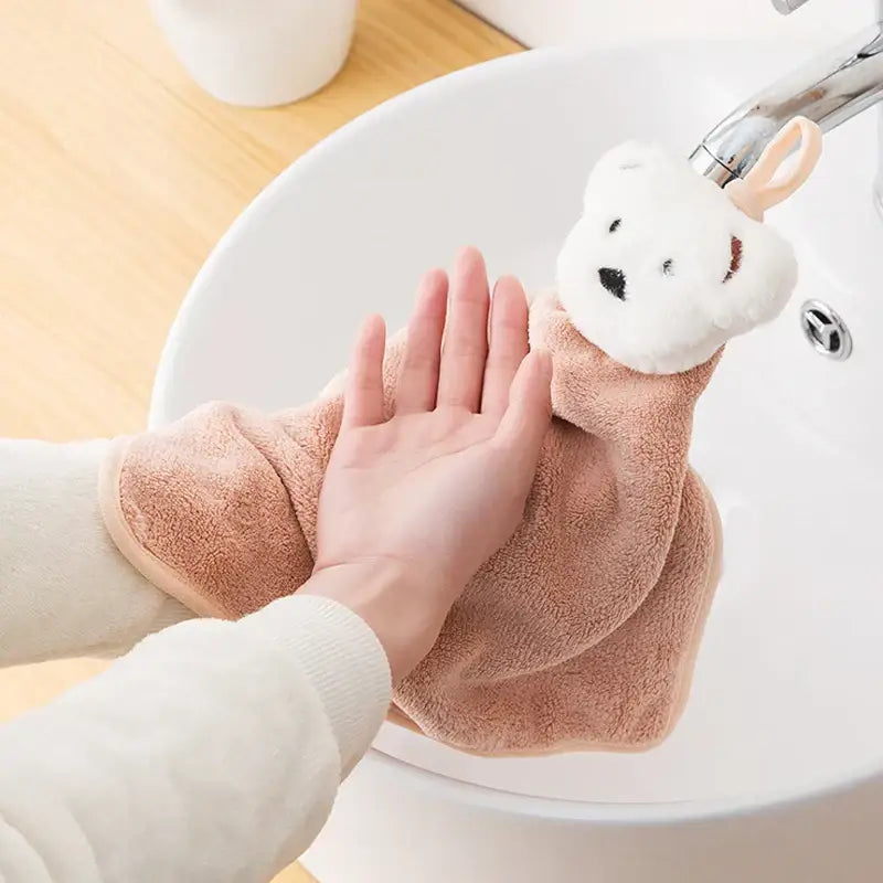 Soft peach-colored plush microfiber hand towel with white decorbites cartoon bear head for kitchen and bathroom use