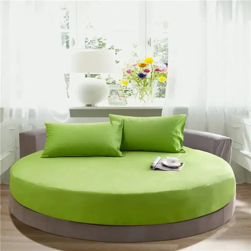 Bright lime green cotton round bed with gray upholstered frame and pillows featuring decorbites cotton round sheet set