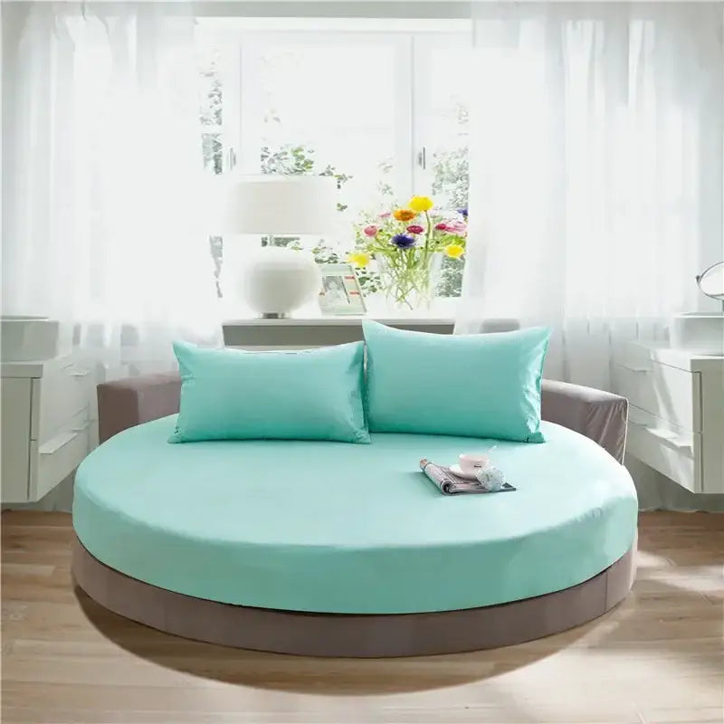 Circular cotton round bed with a soft mint green fabric cover and gray base from decorbites cotton round bed sheet set