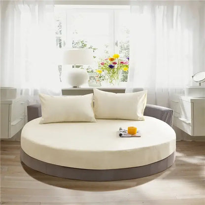 Cream-colored cotton round bed with gray base and pillows featuring decorbites cotton round bed sheet for bedroom bedding