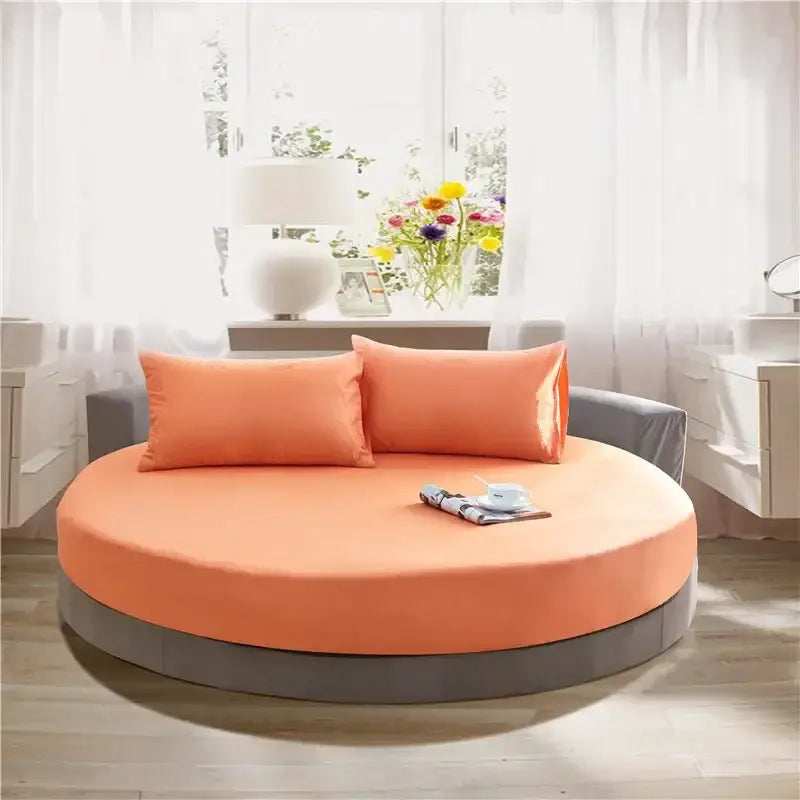 Orange circular daybed with gray base and pillows featuring decorbites cotton round dark gray cotton round bed sheet set
