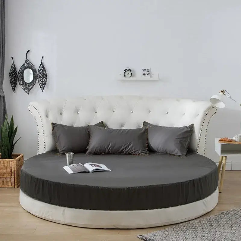 Round bed with tufted white headboard and soft dark gray decorbites cotton round bed sheet set in cotton round bedding