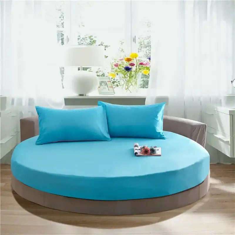 Soft dark gray cotton round bed sheet set on a cotton round bed with vibrant turquoise mattress and matching pillows