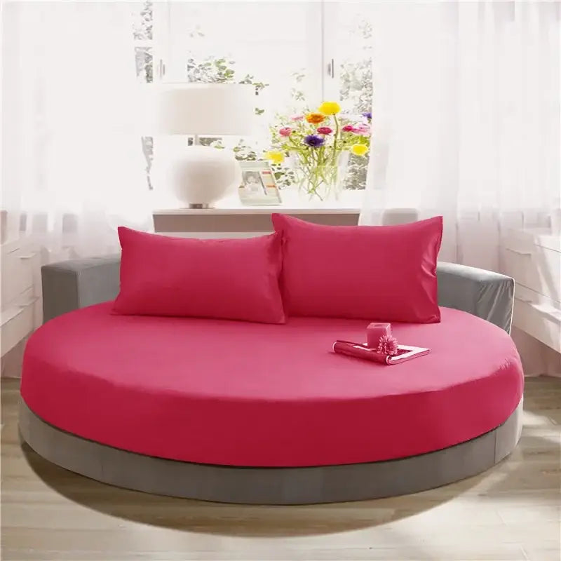 Vibrant fuchsia round bed with gray frame and matching pillows in soft dark gray cotton round bed sheet set by decorbites cotton round