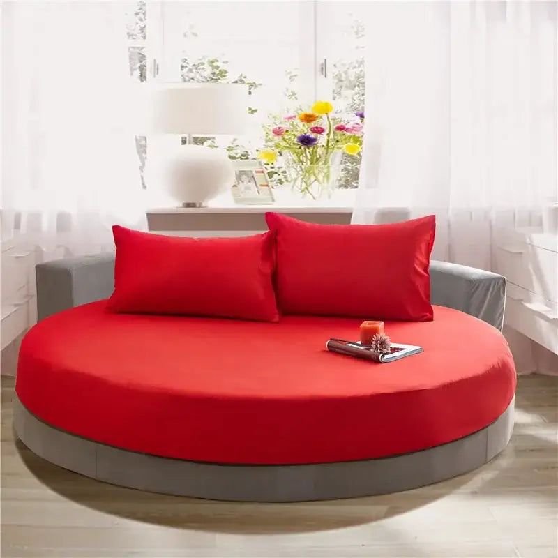 Round bed with vibrant red cotton fabric upholstery and gray frame featuring matching pillows from decorbites cotton round sheet set