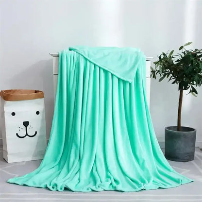 Soft gray cozy flannel warm plush throw blanket in mint green draped on white dresser for decorbites cozy flannel use