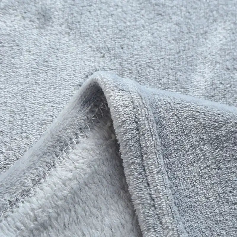 Soft gray cozy flannel warm blanket with plush textured terry cloth and neatly stitched edges by decorbites