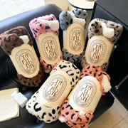 Soft leopard print double layered wool blanket in brown pink gray and orange wrapped around tubes with ta fu boh label