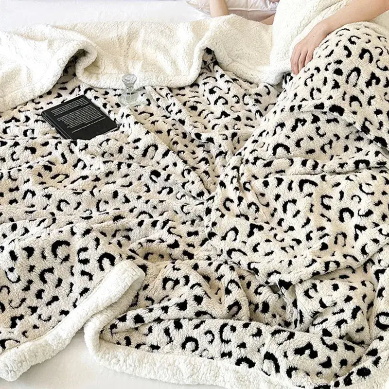Cream-colored plush wool blanket with black leopard print double layered soft fuzzy texture perfect decorbites leopard print throw