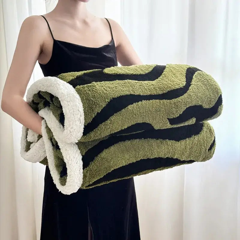 Soft leopard print double layered wool blanket with olive green and black stripes and plush white sherpa lining