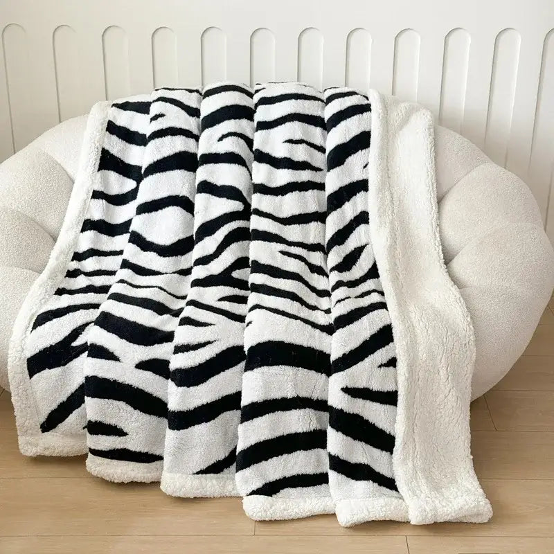 Soft leopard print double layered wool blanket featuring black and white zebra stripes with soft white fleece lining