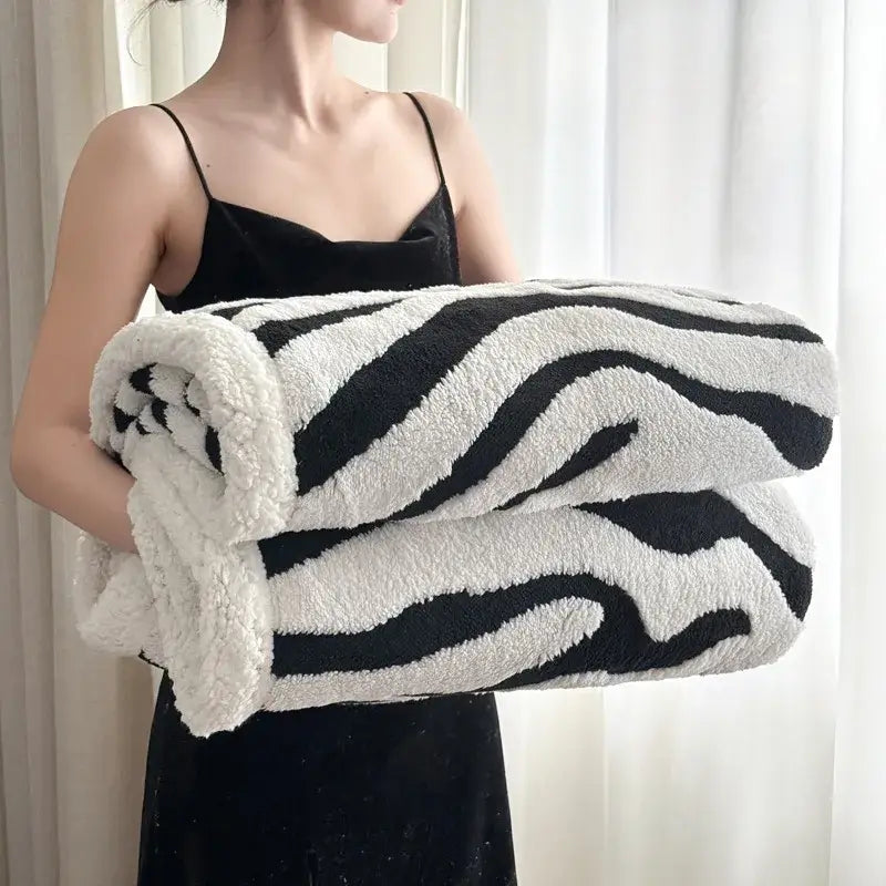 Soft leopard print double layered wool blanket featuring a plush black and white zebra print sherpa texture for decorbites
