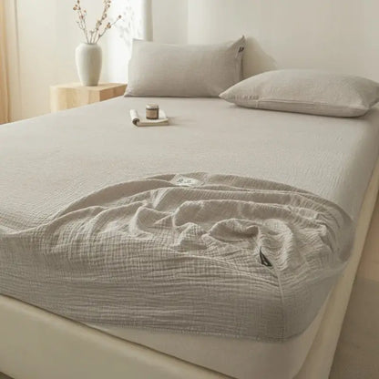 Soft light gray cotton fitted sheet with beige textured finish and subtle pleats for decorbites cotton fitted bed use