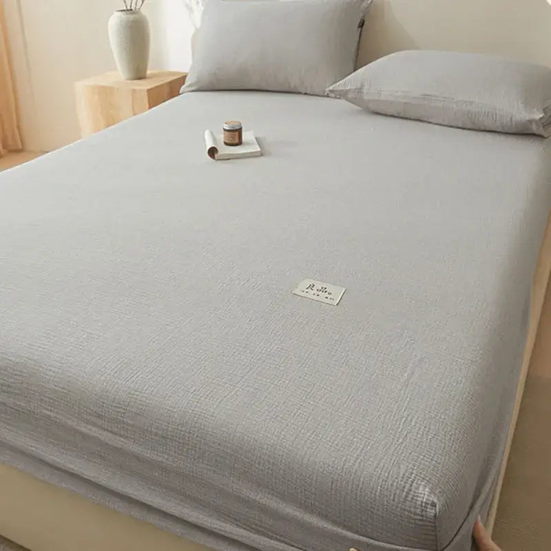 Soft light gray cotton fitted sheet with subtle woven pattern and stitched white label using decorbites cotton fitted design