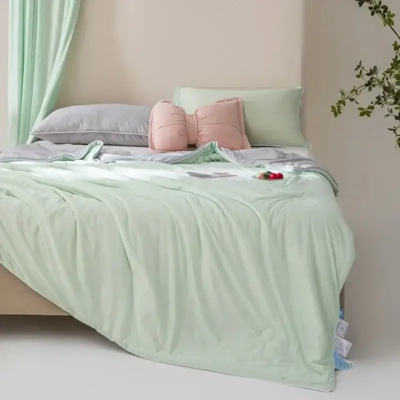 Soft mint green quilted cooling quilt with subtle sheen and cozy texture by decorbites for bedroom comfort