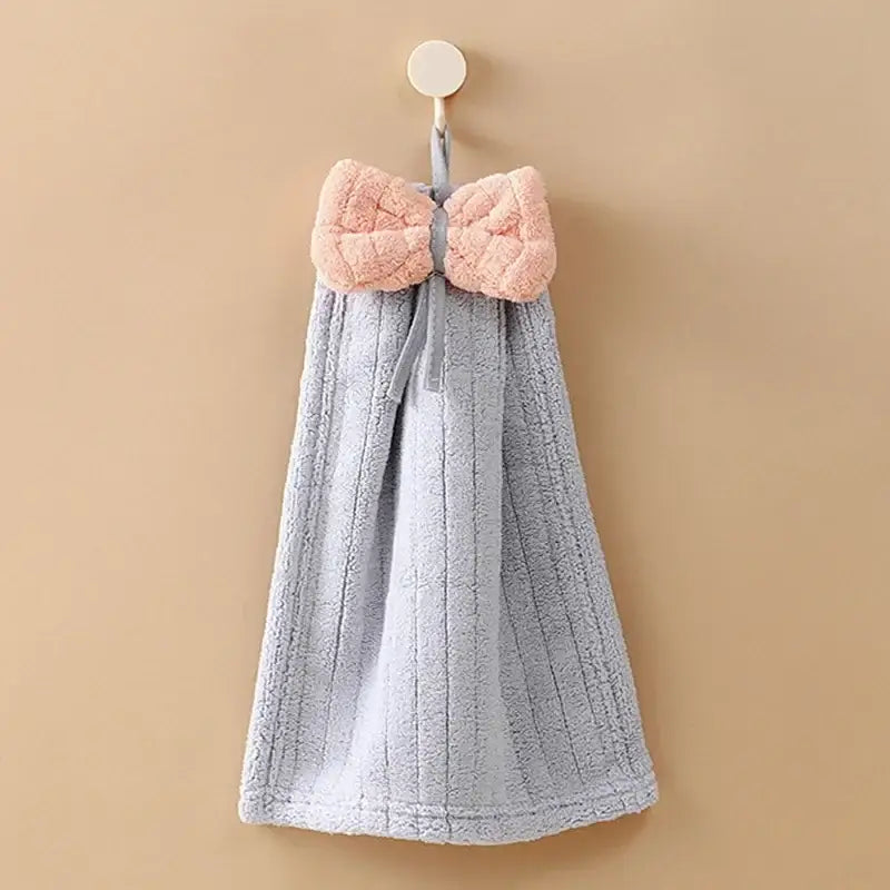 Soft gray decorbites bowknot microfiber hand towel with plush pink bow and ribbed design hanging from a hook