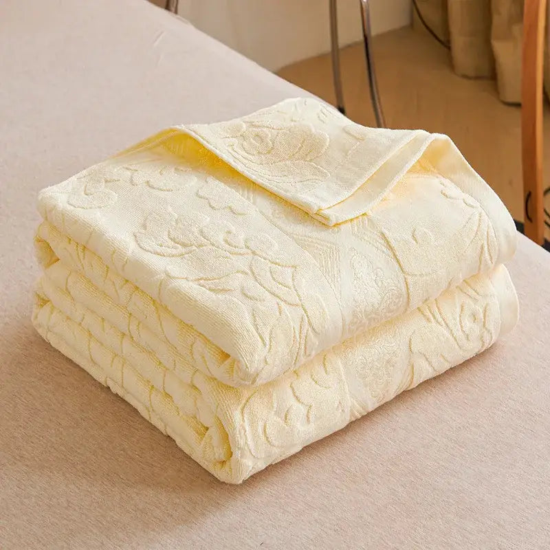 Soft pastel pale yellow decorbites cotton jacquard towel blanket with raised floral pattern and plush texture