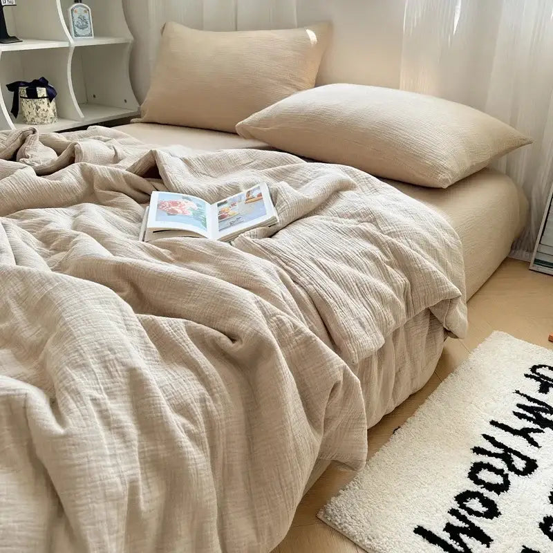 Beige textured cotton duvet set with matching pillowcases draped over bed featuring cooling wrinkled yarn design