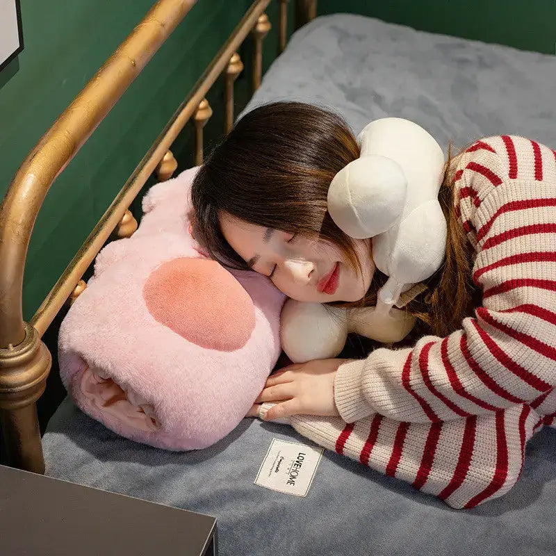 Soft pink cartoon pork plush heating pad with peach snout wrapped around person sleeping on bed decorbites cartoon pork