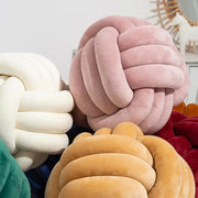 Soft pink velvet knotted ball round cushion featuring a knot-shaped design for bedroom decor