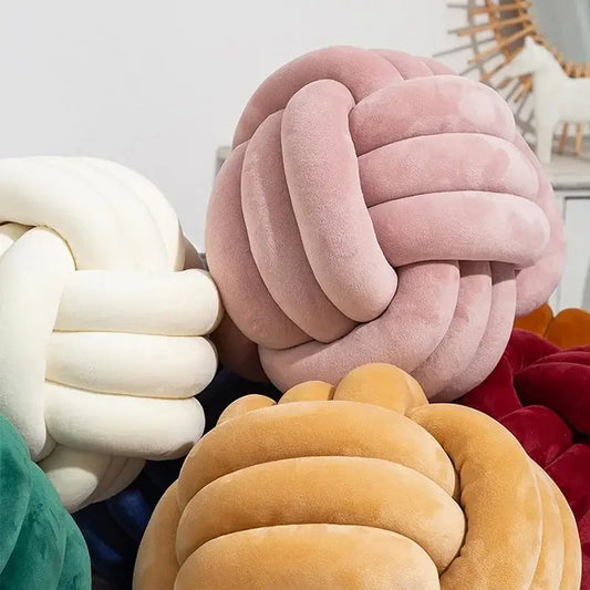 Soft pink velvet knotted ball round cushion featuring a knot-shaped design for bedroom decor