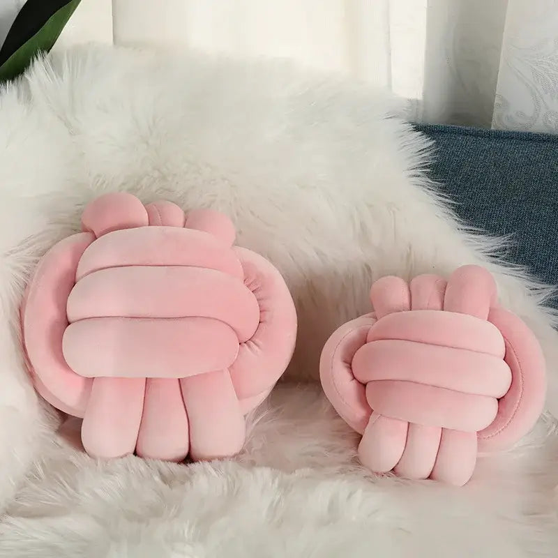 Soft pink velvet knotted ball round plush cushion shaped like a paw for bedroom decor