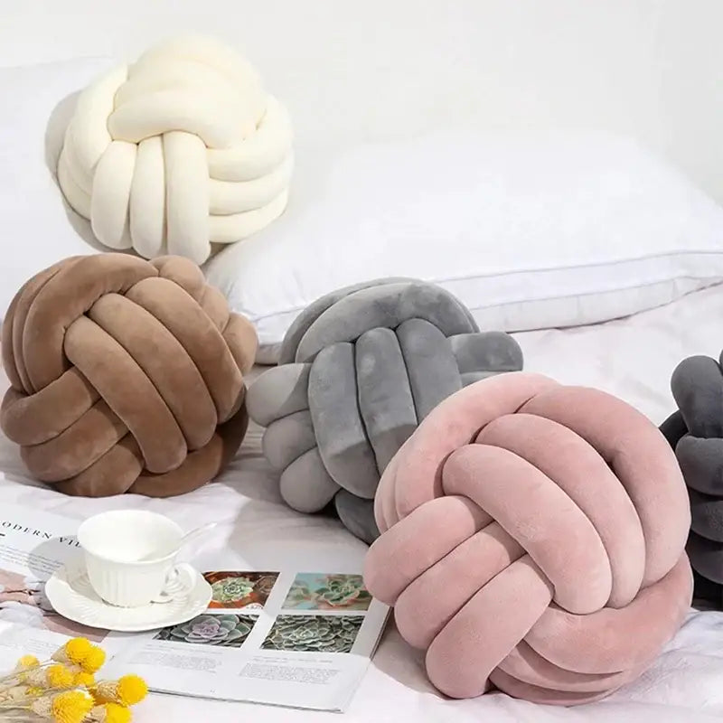 Soft pink velvet knotted ball round pillow with plush knot-shaped pillows in cream taupe gray and blush pink for decor