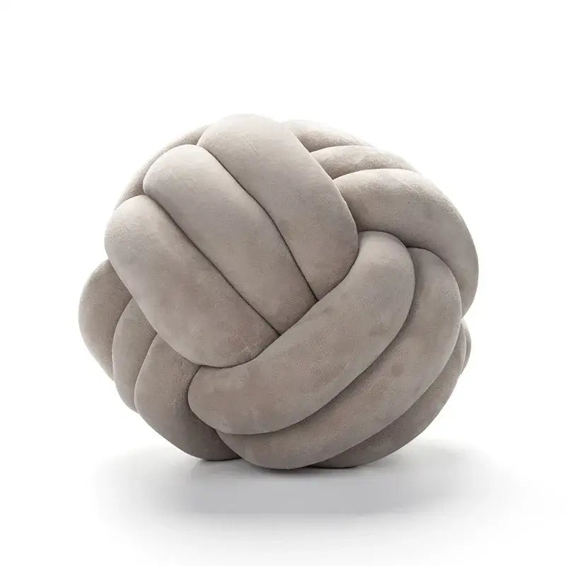 Soft taupe velvet knotted ball round cushion made of plush fabric ideal for bedroom decor and comfort