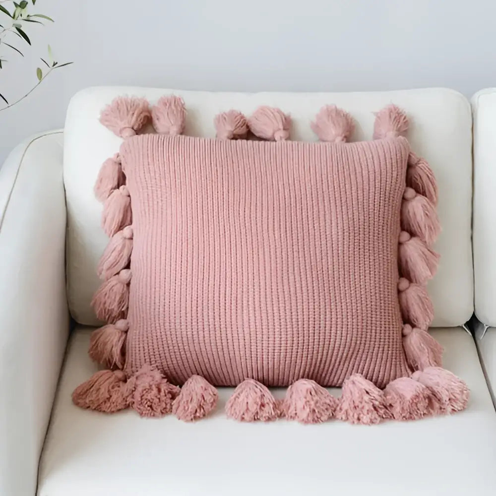 Soft pink knit cushion cover with fluffy tassels for living room decor featuring decorbites knit cushion design