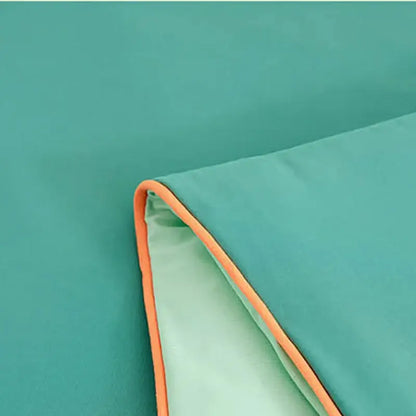 Soft teal summer quilt with bright orange stitched border made from decorbites cool fibre for bedroom comfort