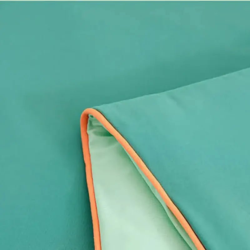 Soft teal summer quilt with bright orange stitched border made from decorbites cool fibre for bedroom comfort