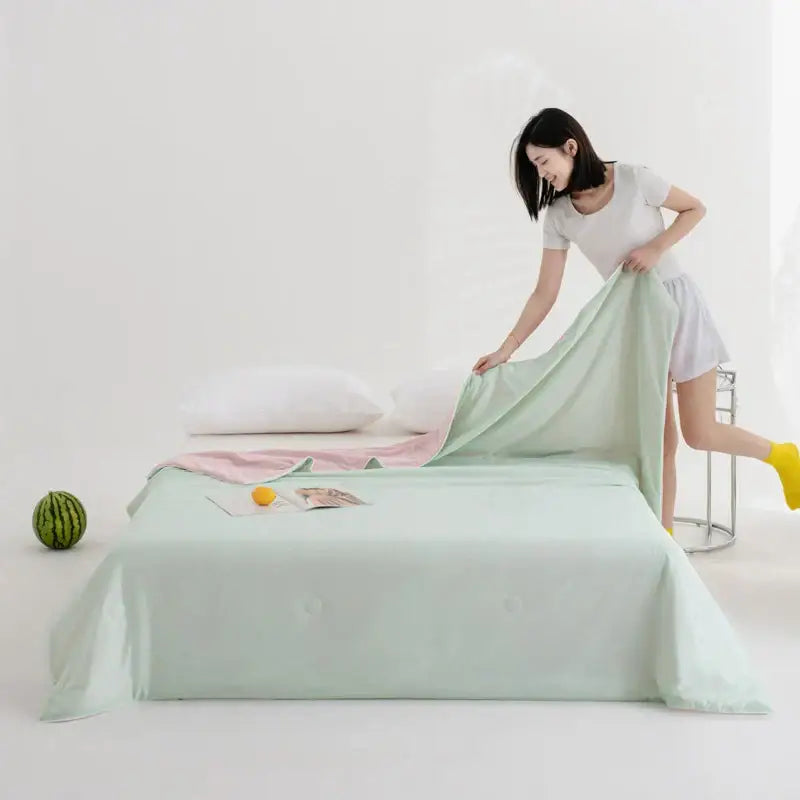 Mint green satin bed sheet paired with soft teal and gold decorbites cool fibre summer quilt for bedroom decor