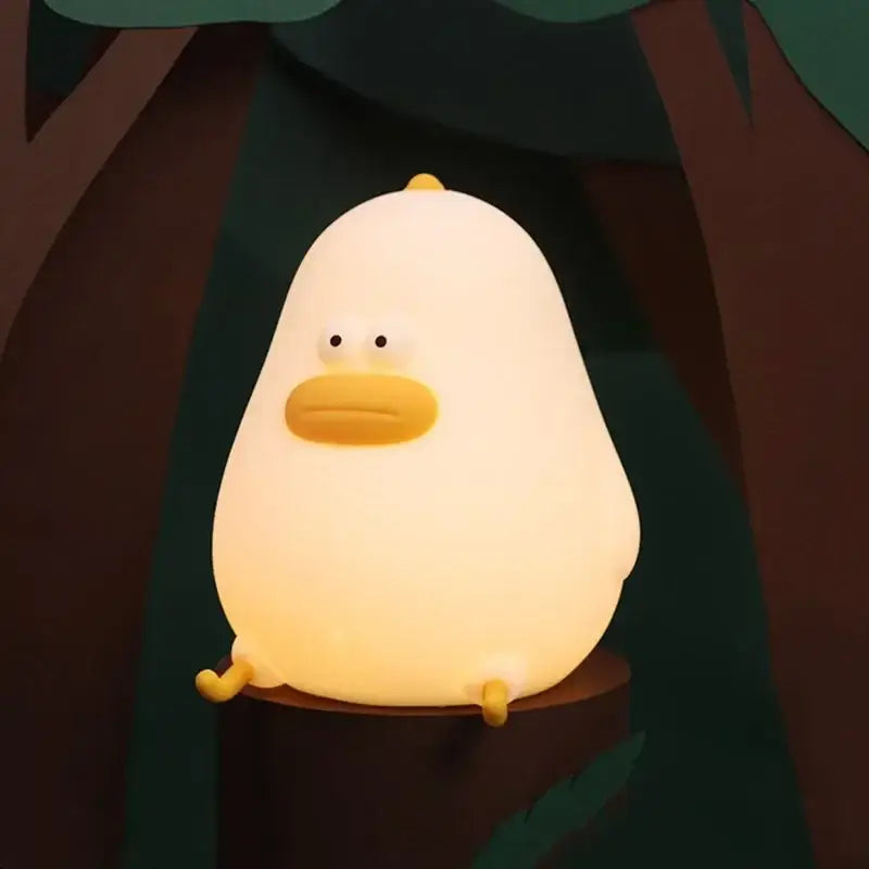 Soft yellow silicone fat chicken night light with a softly glowing white duck shape and yellow beak and feet for bedroom use