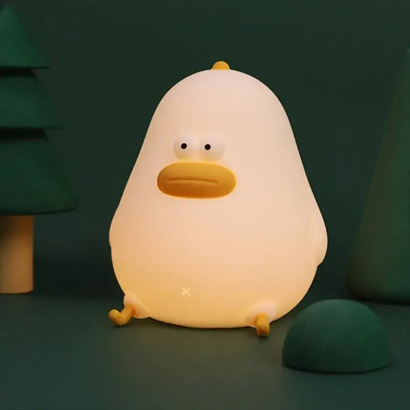 A soft glowing white silicone fat chicken night light with yellow beak and feet for bedroom use