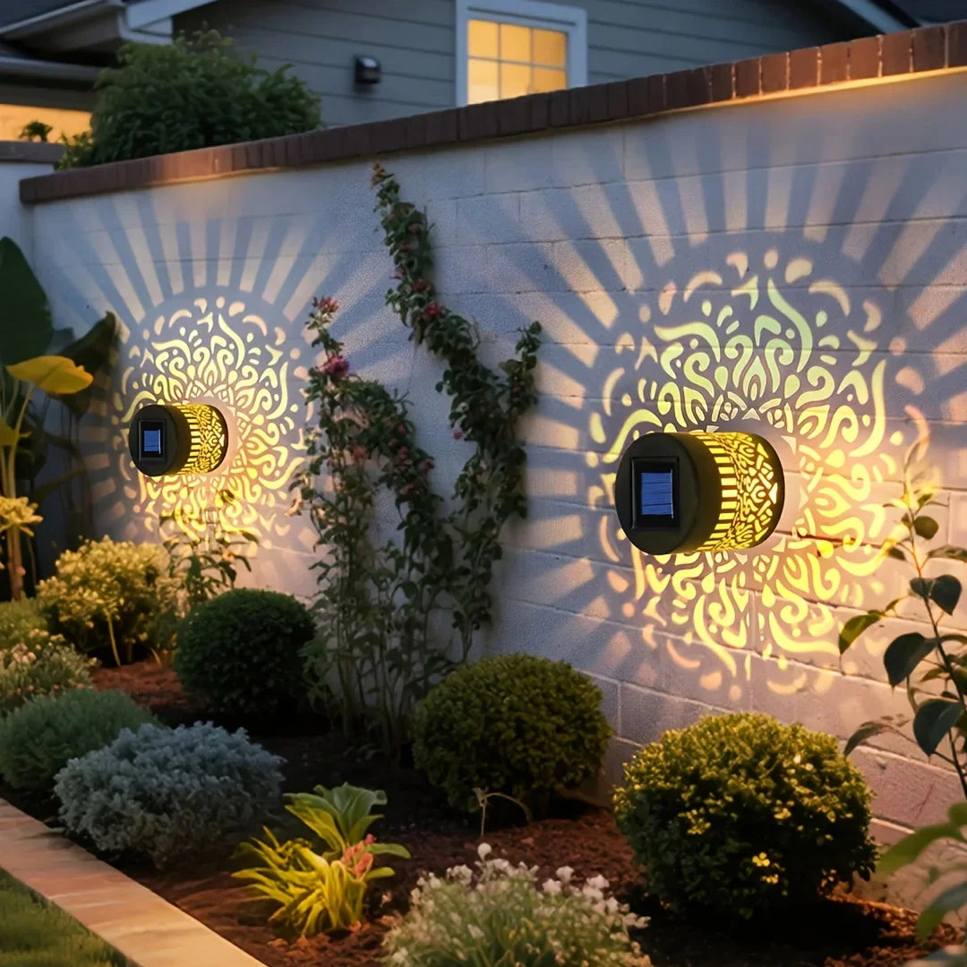 Golden solar-powered datura lantern wall lamp with intricate patterns and black accents for outdoor garden decor