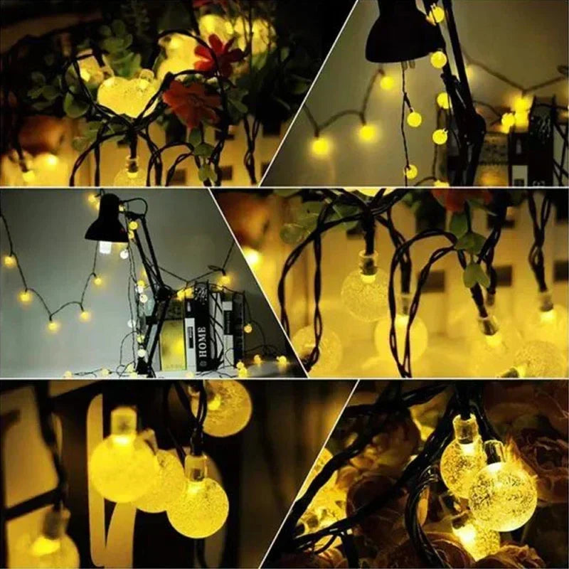 Warm yellow led solar string lights with clear globe bulbs and black wiring for outdoor garden party decor