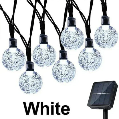 White solar string lights with clear bubble glass bulbs and black wiring for outdoor garden party decor