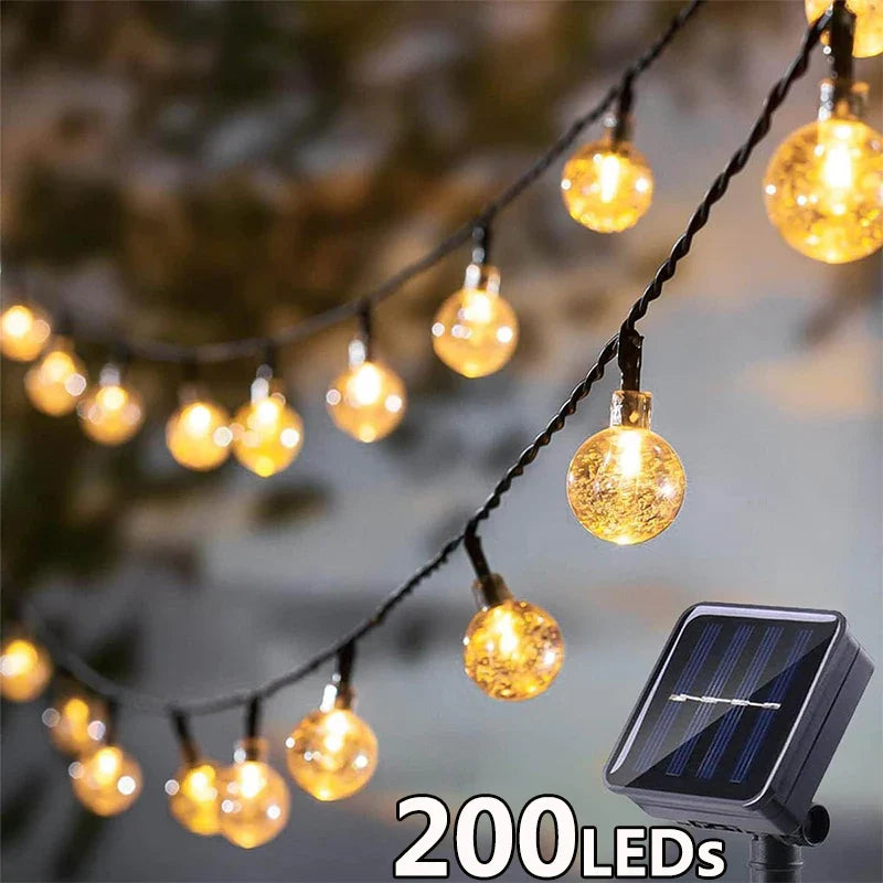 String of warm golden globe-shaped led solar string lights for outdoor garden party decor with 8 modes and waterproof design