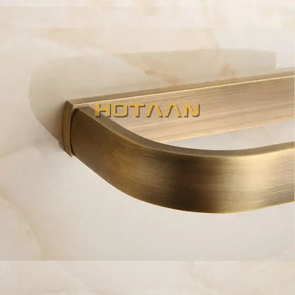 Solid brass finish toilet paper holder with brass-finished brushed metal paper holder and sleek curved design