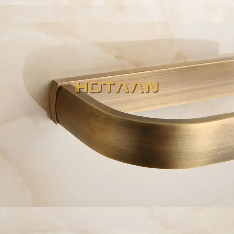 Solid brass finish toilet paper holder with brass-finished brushed metal paper holder and sleek curved design
