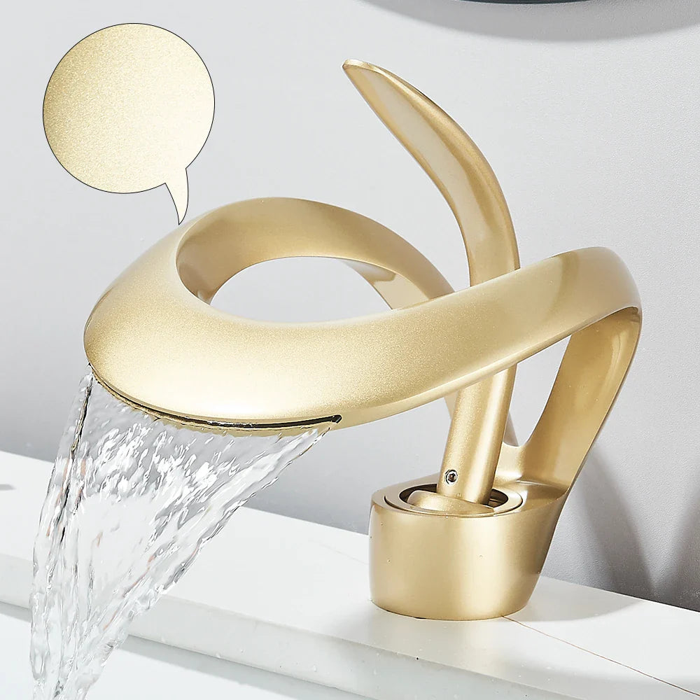 Gold-colored solid brass single hole waterfall basin faucet with sleek curved design for cold water bathroom sink use
